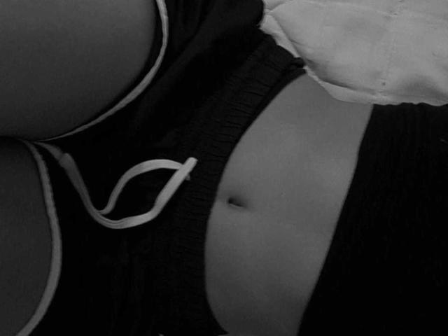 LucyGale's bare belly with a small navel, wearing dark shorts with white trim, and a partially visible white shirt. Boobs in the upper left, ass in the lower left.