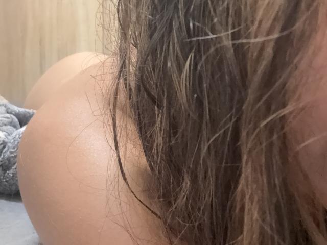 SofieWhite's ass, with wet brown hair covering part of it. Her skin is light and smooth. The image focuses on her buttocks and hair.