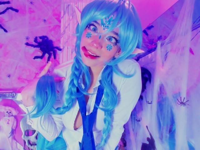 KiraBerry with blue braided hair, elf ears, white shirt, and blue tie, smiling, has snowflake makeup on cheeks, purple and pink lighting, showing cute, fluffy butt in background.