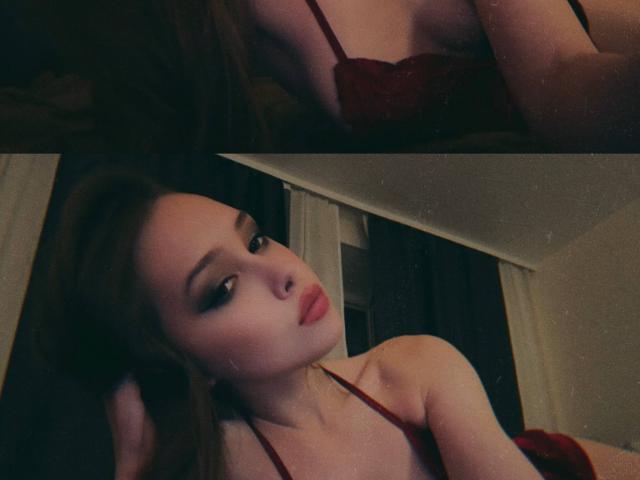 AnyaRuivo with red lace bra, showing her tits, brown hair, and makeup, looking sexy and seductive, lying down, hands in hair, dark and moody lighting.