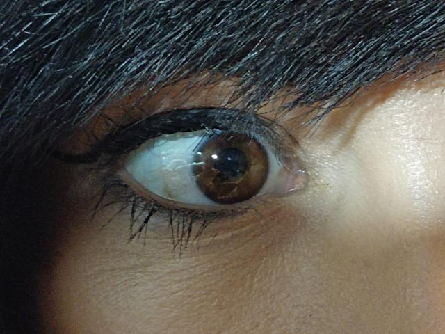 OrianaLaFrancaise heeft een bruin oog met donkere, dikke wenkbrauwen en lange, zwarte wimpers. Haar huid is licht glanzend, en de foto is gefocust op haar rechteroog..