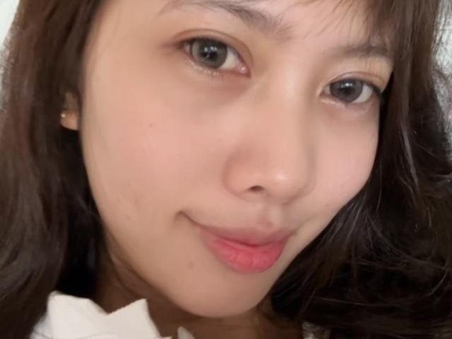 Ressy has a cute face with light brown skin, small nose, and pink lips. She's smiling slightly with dark brown eyes and long brown hair. Boobs are not visible.