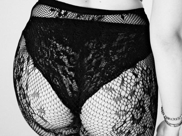 KizzyDepner's black lace panties and fishnet stockings, showing her butt, with lace pattern and fishnet texture, highlighting her round, exposed ass.
