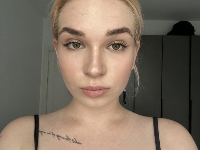 Chassidy Kulju hat blondes Haar, grüne Augen und ein Tattoo auf ihrer rechten Brust. Sie trägt ein schwarzes Top mit Spaghetti-Trägern, hat volle, rosafarbene Lippen und feine Sommersprossen..