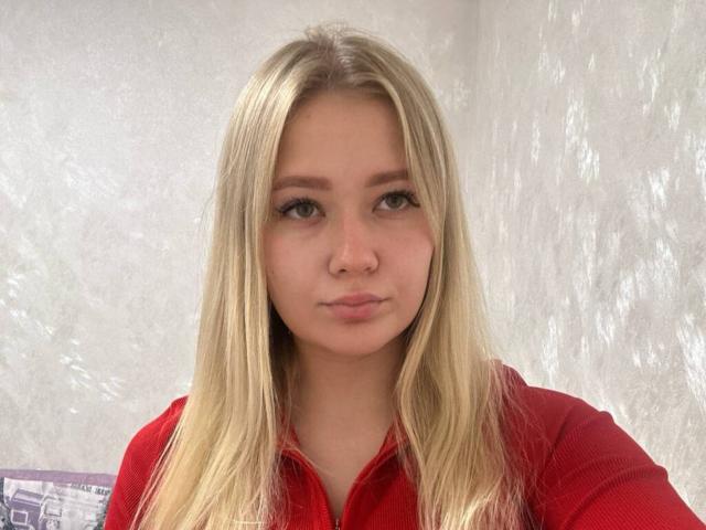 ThaoSakiestewa heeft lang blond haar, groene ogen en een schattig gezicht met een lichte frons. Ze draagt een rode top met rits en heeft een kleine neusring..