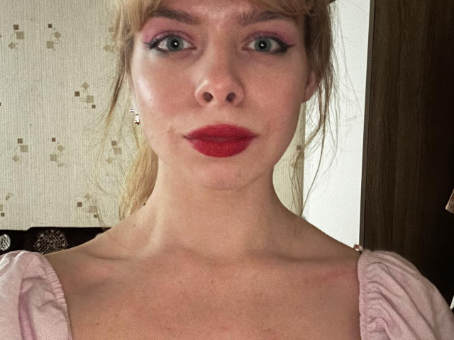 NellieVanduyne tiene ojos azules, sombra de ojos rosa, lápiz labial rojo y lleva un vestido rosa con mangas abullonadas. Su cabello rubio está recogido en una coleta. Sus senos son visibles..