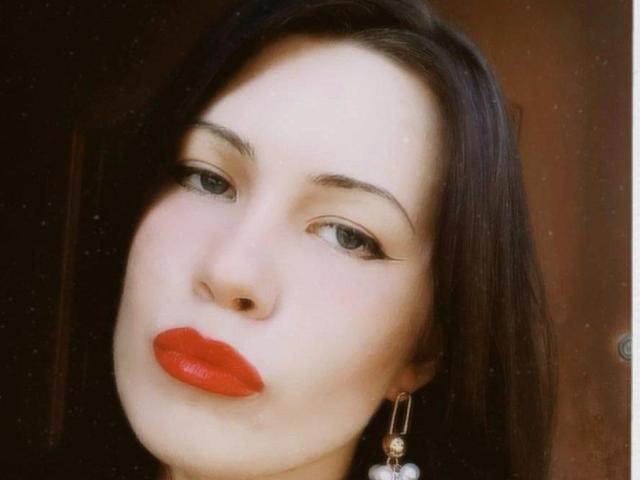 MistyRuyz tiene la piel pálida, cabello negro y lacio, ojos verdes, delineador de ojos negro y grueso, y lápiz labial rojo brillante. Lleva un arete de oro con una gema blanca..
