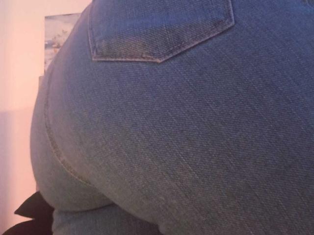 ZarayFeet's blue denim butt, showing a tight, textured, and slightly curved rear with a visible back pocket. The focus is on the denim-covered buttocks.