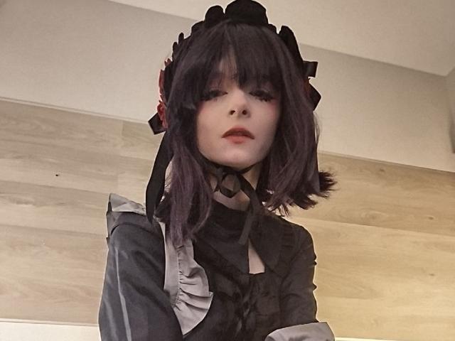 ChangCaddle with dark purple, shoulder-length hair wearing a black maid outfit, black headpiece with red roses, white collar, and black choker, looking up with a neutral expression.