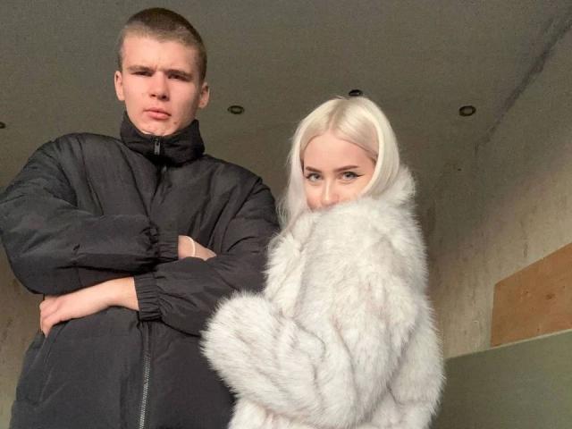 KevinKRYSTALLL-hot with short brown hair in a black puffy jacket, arms crossed, next to KevinKRYSTALLL-hot with platinum blonde hair, white fur coat, looking back.