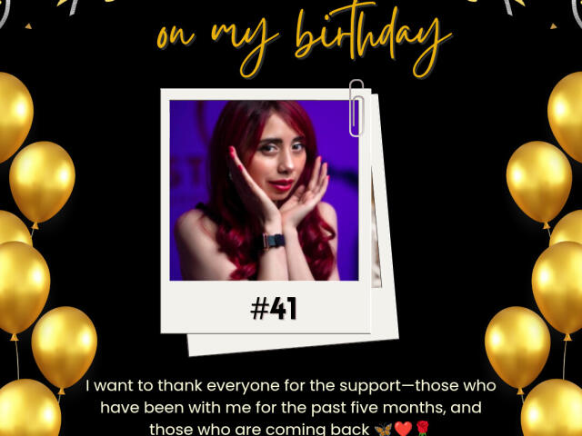 StephanieSun has red hair, a cute face, and is touching her cheeks with hands up. She's wearing a black wristband. Golden balloons surround her. #41.