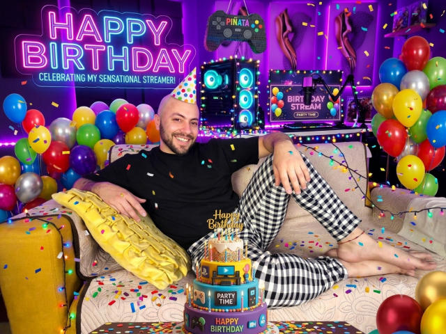 MikeLoverss, bald with a beard, black shirt, checkered pants, smiling, sitting on a couch with balloons, confetti, and a birthday cake in front, neon lights in the background.