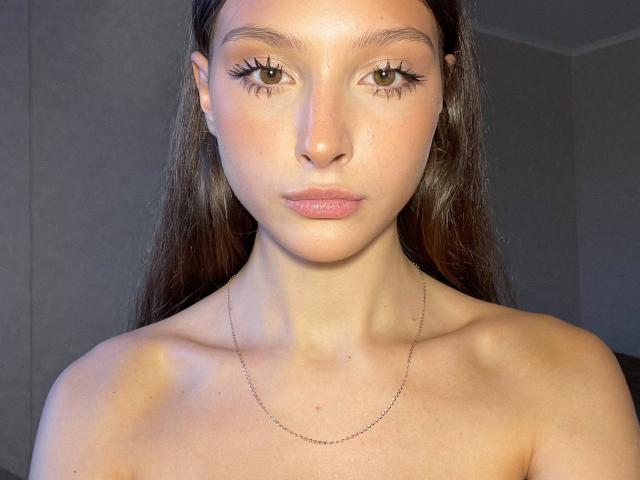 Kassandra Dalal ha lunghi capelli castani, occhi castani ed è senza top, con un collo sottile, indossando una sottile collana a catena. Il suo seno è piccolo e il suo viso è neutro..