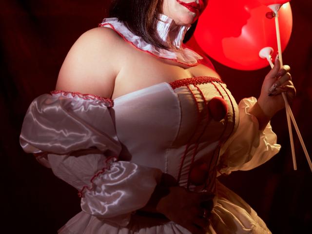 SamanthaVenus in a white, off-shoulder, puffy-sleeve dress with red trim, holding a red lantern, exposing her large, shiny, bare boobs, and wearing a white ruffled choker.