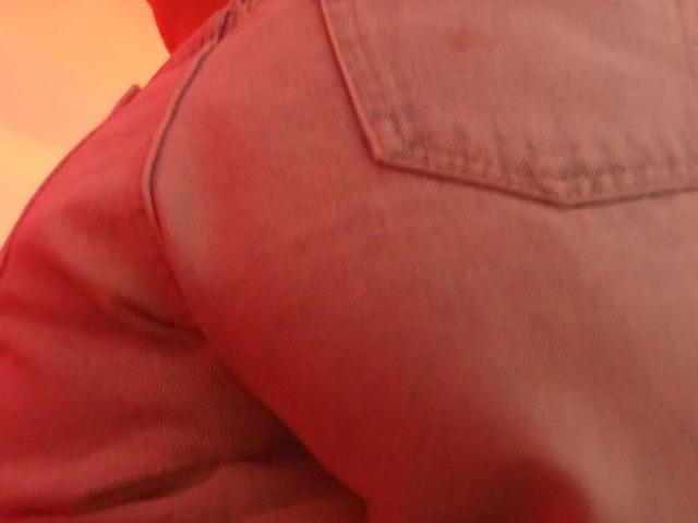 ZarayFeet's ass in tight, faded blue jeans, showing a prominent back pocket and slight redish light reflection on the fabric.