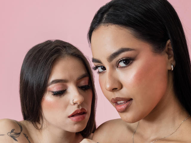 PaolaYKatty with dark hair and makeup, looking at camera, has pink eyeshadow, nose ring, and tattoo on shoulder. Another PaolaYKatty with glossy pink lips, dark hair, and earrings.