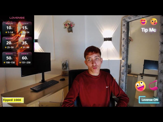 SantiagoColeman with red shirt, short brown hair, and a neutral expression, sitting in front of a computer, showing a tipped 1000 love stream notification.