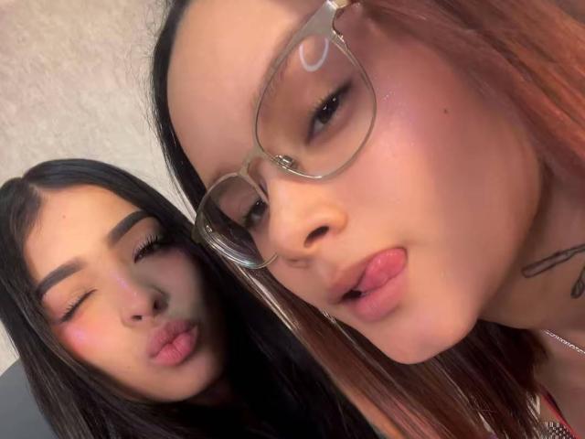 AmberYZafiro has her tongue out, wearing glasses, with her pouty lips and tattoo. Another AmberYZafiro, with one eye closed, pouts too. Both have dark hair and pink blush.