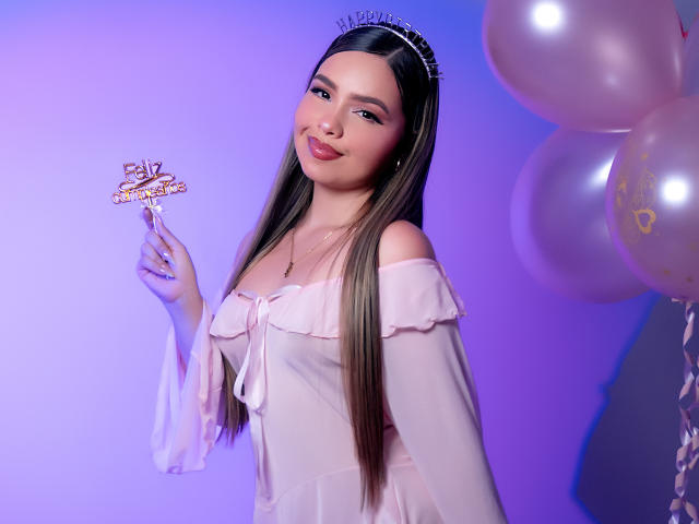 AngelRoussy with long brown hair, pink off-shoulder dress, holding "21st Birthday" crown, smiling, pink balloons, purple light, tiara, small tits, cute, sexy.