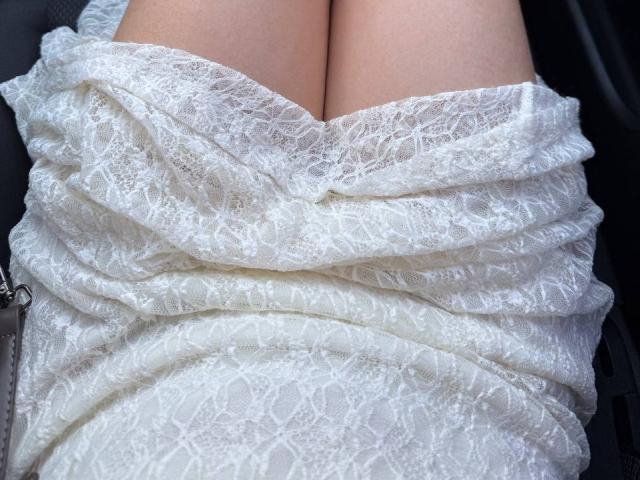 Teffi's white lace-covered butt, wrapped in a textured, patterned fabric, showing a modest cleavage. Her pale skin is visible at the top. Teffi's lace dress is tight.