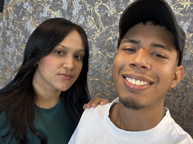 SofiaAndAndres has long black hair, a green shirt, and a slight smile. Andres has a black cap, white shirt, and a happy grin with a goatee.