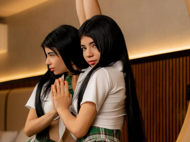 RoxanneeSecret with long black hair, white shirt, green plaid skirt, hands together, arms raised, reflection in mirror, looking side, red lipstick, soft indoor lighting, sexy, cute.