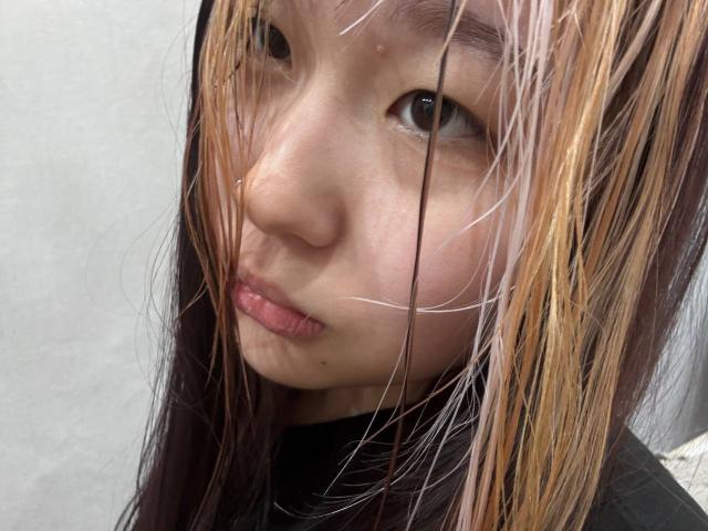 JungMcgranor has dirty-ass brown and blonde hair, slightly parted lips, and a small nose ring. She's staring with a neutral expression, looking straight into the camera.