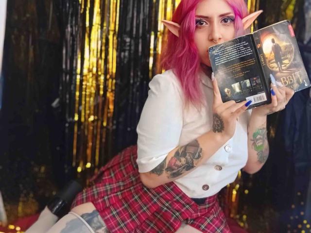 AliceCalloway with pink hair, elf ears, white shirt, red plaid skirt, holding a book, tattoos on arms, blue nails, sitting, sexy, cute, book cover visible, black and gold background.