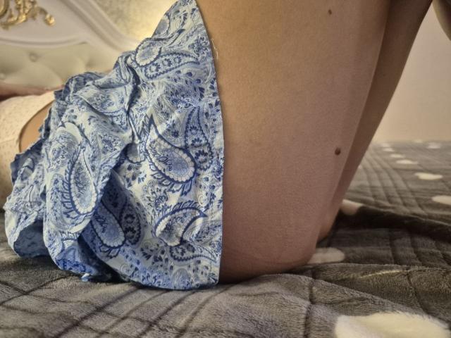 TenerliRize's blue paisley-patterned panties are pulled down, exposing their bare, pale-skinned ass and a small black mole on the right side of their upper thigh.