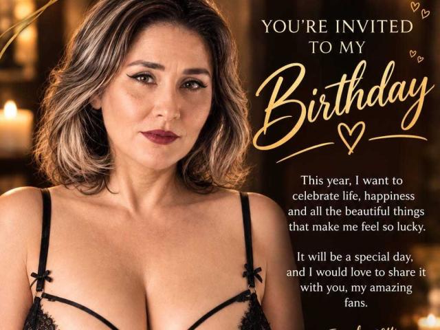 BilexyMature has medium-length brown hair, wearing black lace lingerie with visible boobs, looking at the camera with a slight smile. She has a fair skin tone and dark lipstick.