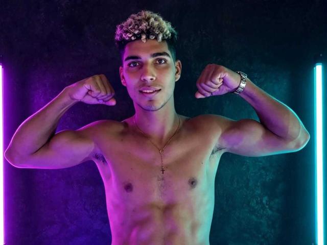 SantiaGodiazz, shirtless, flexing muscles, short curly blonde hair, tan skin, small cross necklace, silver watch, purple and blue neon lights, smiling, standing, fit, toned, confident.
