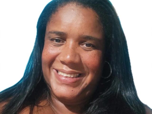 Stefanynui has dark brown skin, long black hair, and a smile showing teeth. She's wearing a silver hoop earring on her right ear. Her nose is slightly upturned.