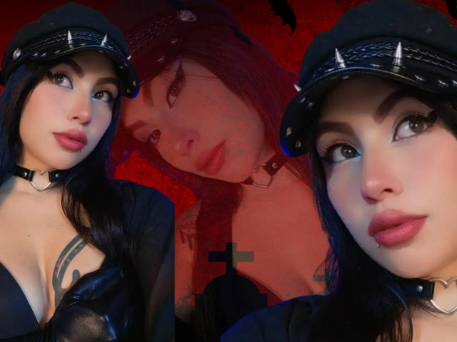 DominicTheOne has pale skin, black hair, and wears a spiked black cap and choker, showing tits in a black top, with a third image of her face in the background.