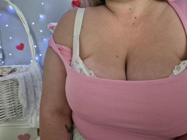 RadaRori's big, chubby tits in a pink ribbed top with white lace bra straps showing, soft pink skin, and a small tattoo on her upper arm.