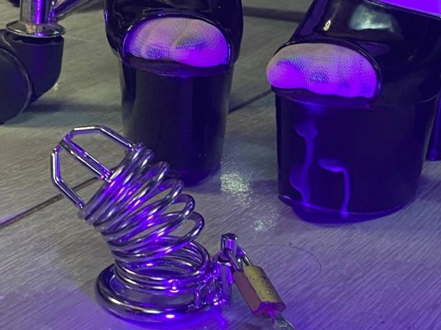 LilithStorm's shiny black high heels with white mesh tops, next to a metal butt plug with a purple LED light and a gold lock.