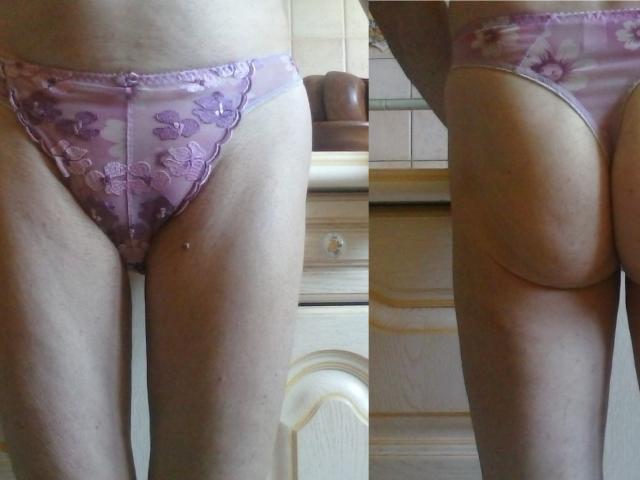 Hermeline's pink floral panties, showing her pussy from the front and her ass from the back, in a split-view photograph. Her skin is light, and she's standing indoors.