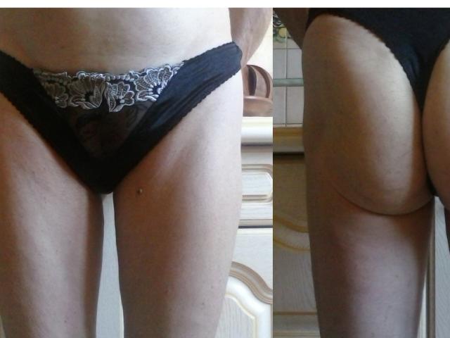 Hermeline's ass in black lace panties, showing her buttcheek and a small hole near her hip. Side and rear view, showcasing her pale skin and butt crease.