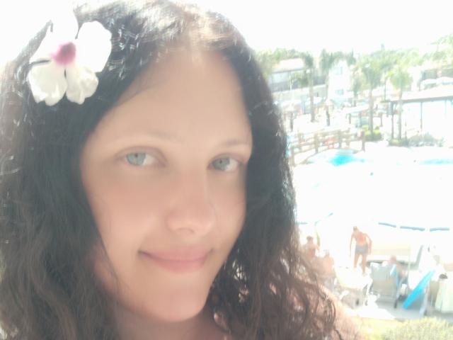 Close-up of a Japanese-style flag with a bold, red circular emblem in the center. The emblem is slightly faded, showing signs of wear. Soft, muted colors dominate.