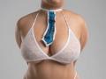 SofieMalory wearing a white lace bralette with a blue and white tie hanging in front of her large, exposed tits. Her arms are behind her back.