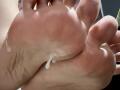 FiorellaNox's soles, shiny with white, sticky liquid dripping from her toes, showing her pink, slightly dirty feet and visible toe hair in a tight, close-up shot.