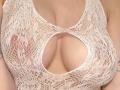 Keiri's big, bare tits are visible through a white, lace, see-through top with a cut-out, exposing her nipples. Her light skin is slightly tan.