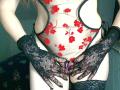 Close-up of AromaLove's chest, wearing a white top with red floral patterns, black lace gloves, and black lingerie. AromaLove's hands gripping their crotch, creating a sexual tension vibe. Bright contrast.