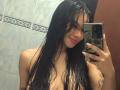 Yurimy with wet black hair, red lips, and small bare boobs taking a mirror selfie in a bathroom, holding a phone with a green case.
