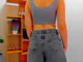 Steisii with tan skin, gray sports bra, and blue jeans, showing a toned ass and back, standing in front of a wooden shelf.