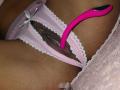 Amberv's pink lace panties are pulled to the side, revealing her pussy with a bright pink vibrator partially inserted. Her dark brown skin contrasts with the light pink fabric.