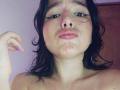 ValeriHairy69 has wet, dark hair, black eyeliner, and drool on her face, with a small tattoo on her left shoulder. Her pink lips are slightly parted.