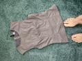 Grey sports bra with a black strap on a green carpet, lying flat. HeartlessQueenn's bare feet with pink toenails are on the right side.