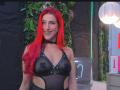 AlissaBrown with bright red hair, wearing a black sheer harness that exposes her tits, smiling with a black choker. Her nipples are visible through the fabric.