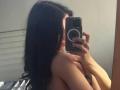 ShylaCatillo, with long black hair, takes a mirror selfie with a smartphone, partially covering her bare breasts with her hand. Her phone has a circular ring on the back. Fucking sexy.