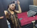 EmilyVidal in a black fishnet dress showing her tits and pussy through the holes, taking a mirror selfie with a smartphone, red nails, and a confident smile.